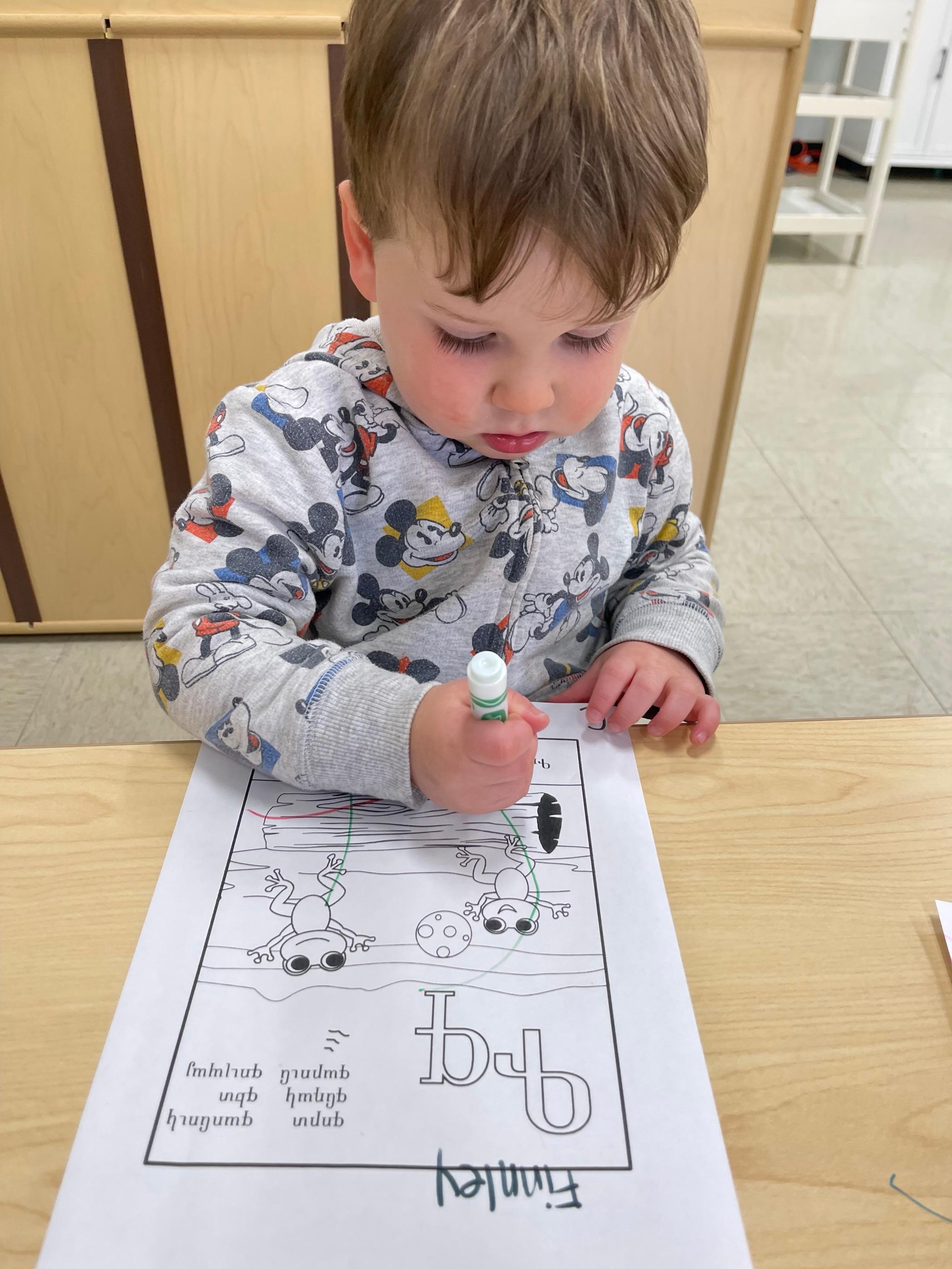 kid coloring an artwork